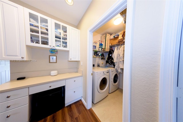 laundry area with dark hardwood / wood-style flooring and washing machine and dryer