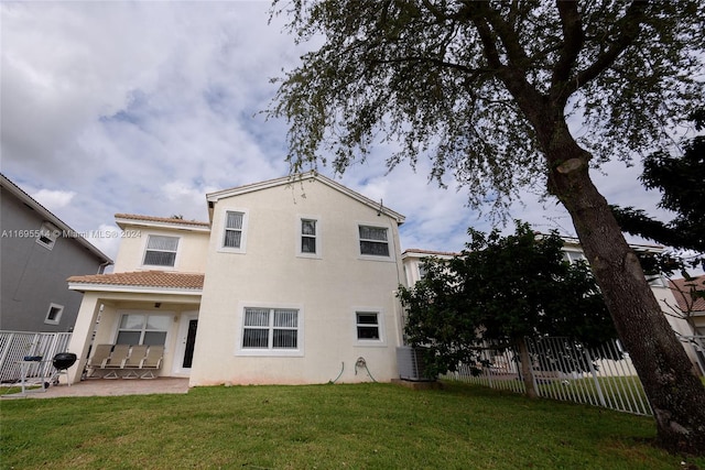 rear view of property featuring a patio, cooling unit, and a lawn