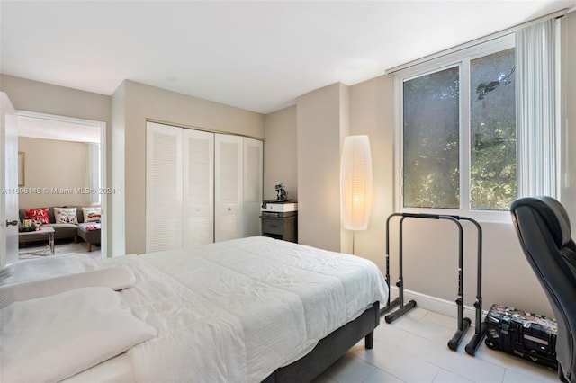 tiled bedroom featuring a closet