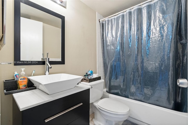 full bathroom featuring shower / bath combination with curtain, vanity, and toilet