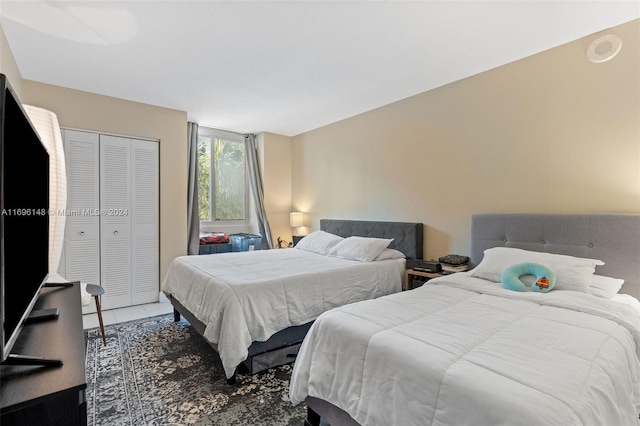 bedroom featuring tile patterned floors and a closet