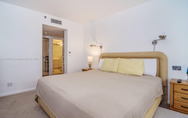 bedroom featuring carpet flooring and ensuite bath