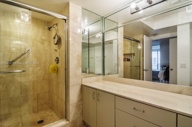 bathroom featuring vanity and a shower with shower door