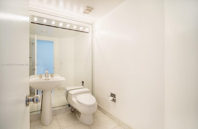 bathroom with tile patterned flooring and toilet