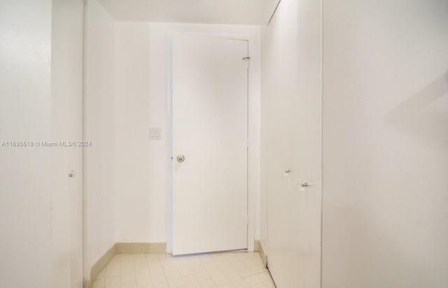 hallway with light tile patterned floors