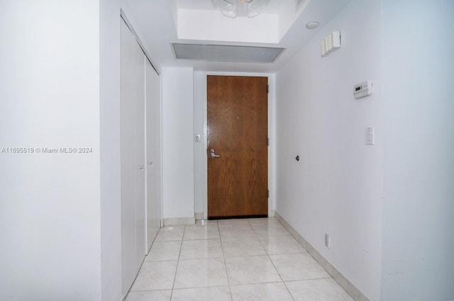 corridor featuring light tile patterned floors