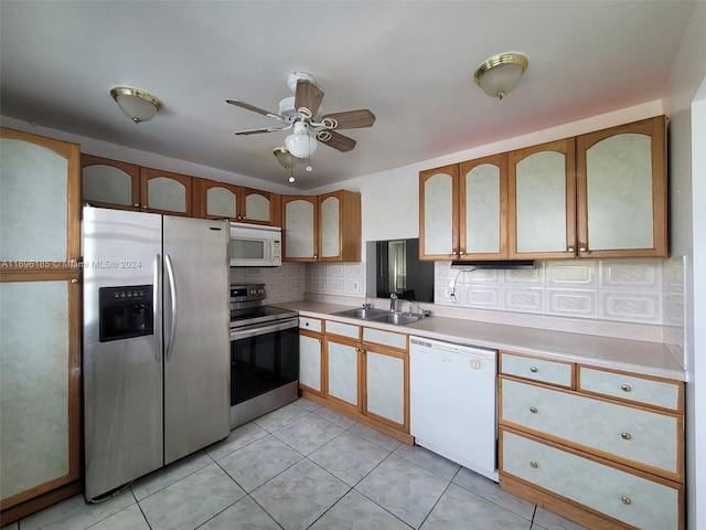 kitchen featuring sink, ceiling fan, decorative backsplash, appliances with stainless steel finishes, and light tile patterned flooring