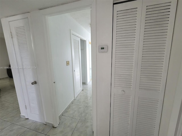 corridor with light tile patterned floors