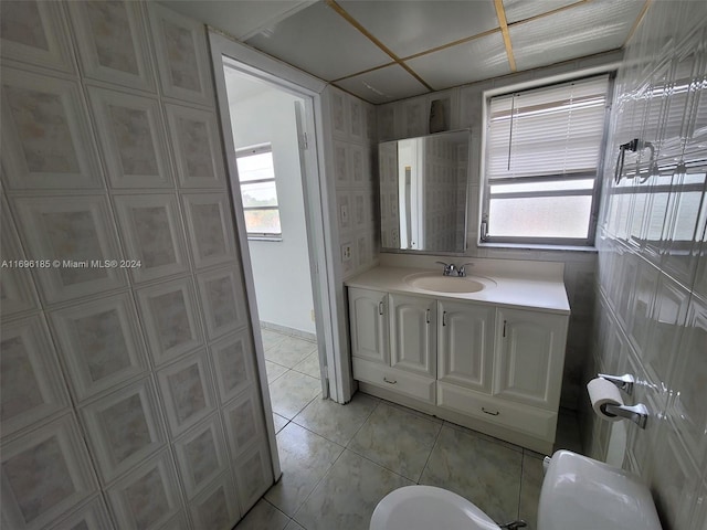 bathroom featuring tile patterned floors, vanity, and toilet