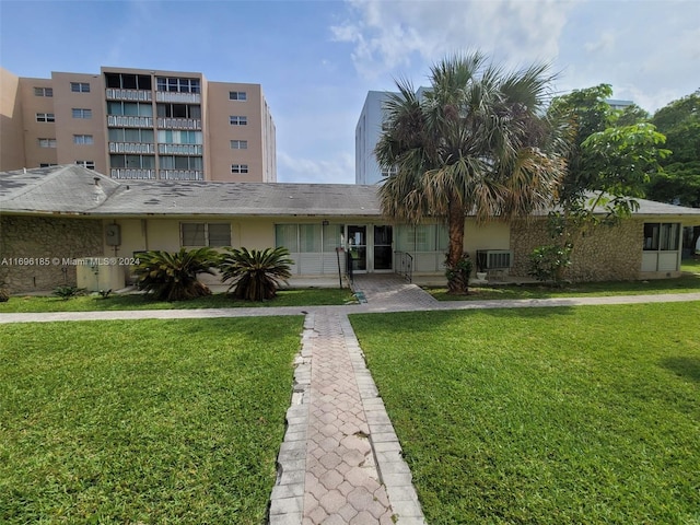 view of front of home featuring a front yard and central AC unit