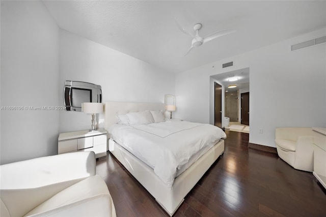 bedroom featuring connected bathroom, ceiling fan, and dark hardwood / wood-style flooring