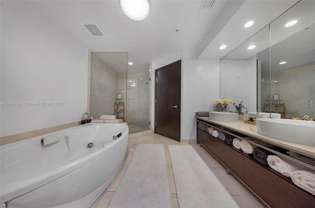 bathroom with plus walk in shower, vanity, and tile patterned floors