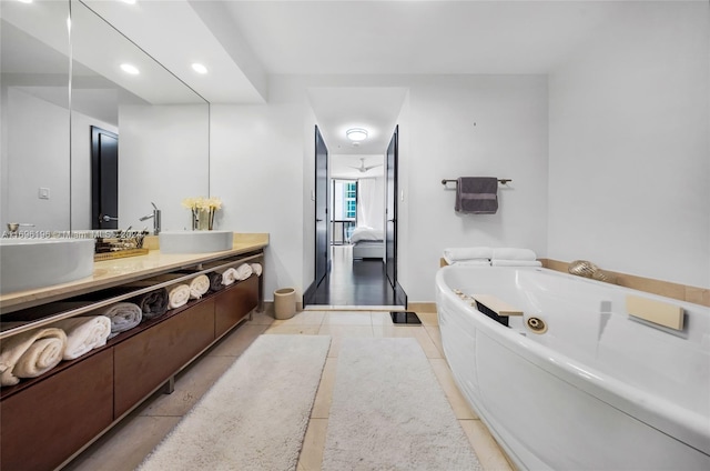 bathroom with tile patterned floors, vanity, and a bathtub