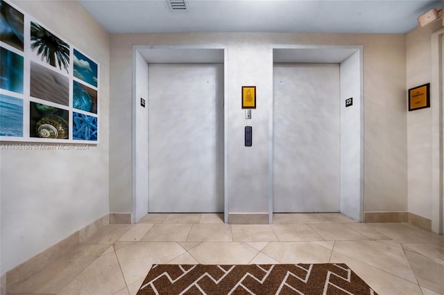 hallway with light tile patterned floors and elevator