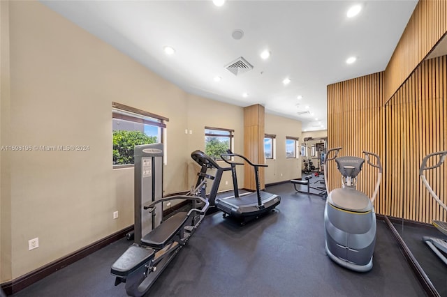 exercise room featuring wooden walls