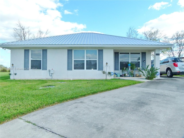 single story home with covered porch and a front yard