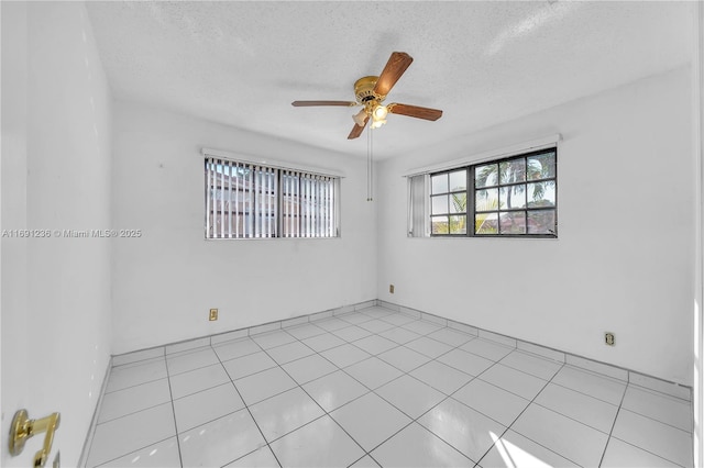 unfurnished room featuring ceiling fan and a textured ceiling