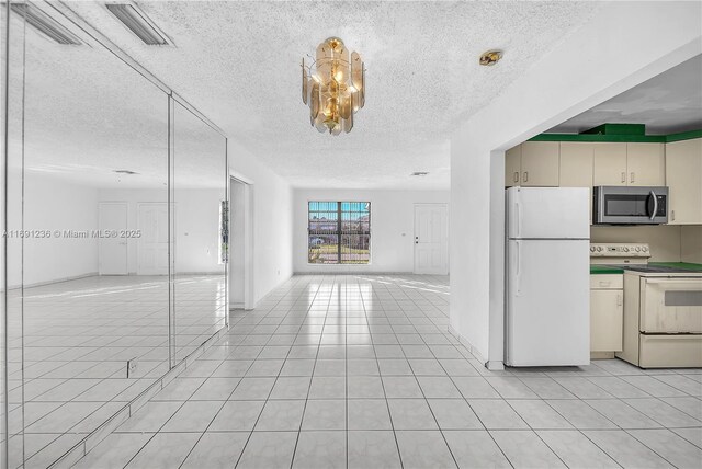 unfurnished bedroom featuring ceiling fan, multiple closets, and light tile patterned flooring