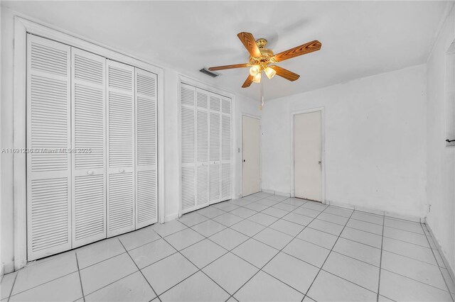 tiled spare room featuring a textured ceiling, ceiling fan, and lofted ceiling