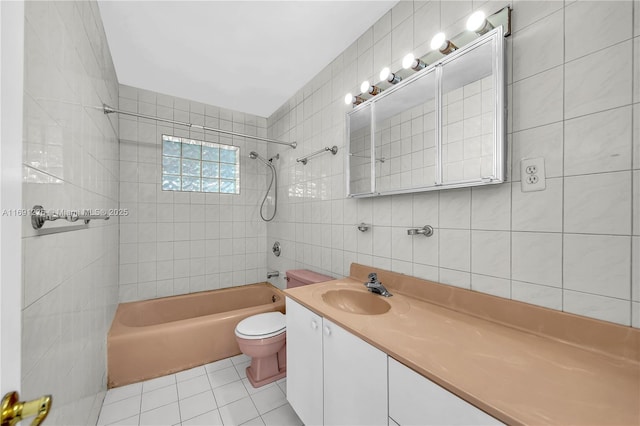 bathroom featuring vanity,  shower combination, tile walls, toilet, and tile patterned floors