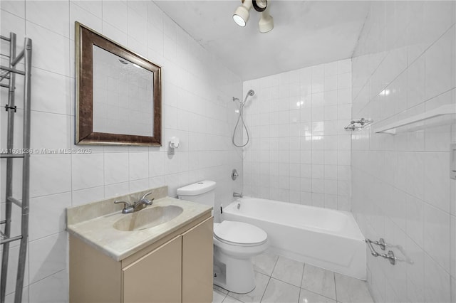bathroom with toilet, vanity, bathtub / shower combination, tile patterned floors, and tile walls