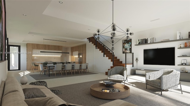 living room featuring carpet floors, a tray ceiling, and an inviting chandelier