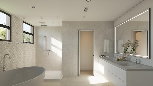 bathroom featuring tile patterned flooring, vanity, tile walls, and independent shower and bath