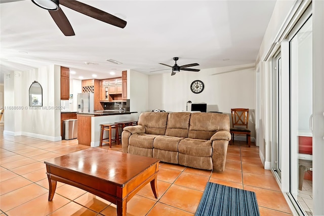 living room featuring ceiling fan and light tile patterned floors