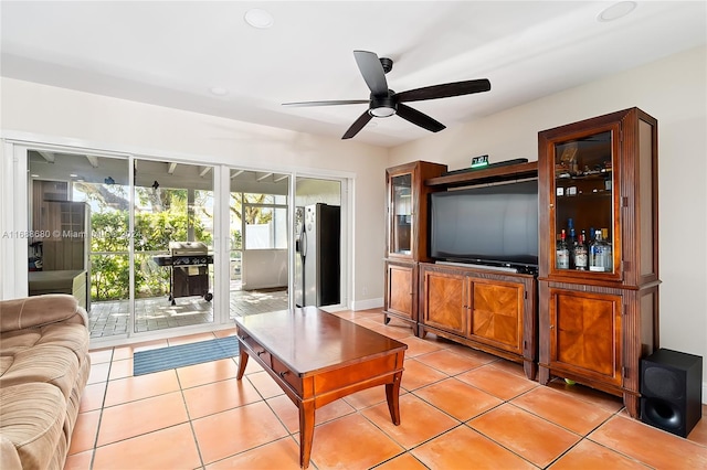 tiled living room with ceiling fan