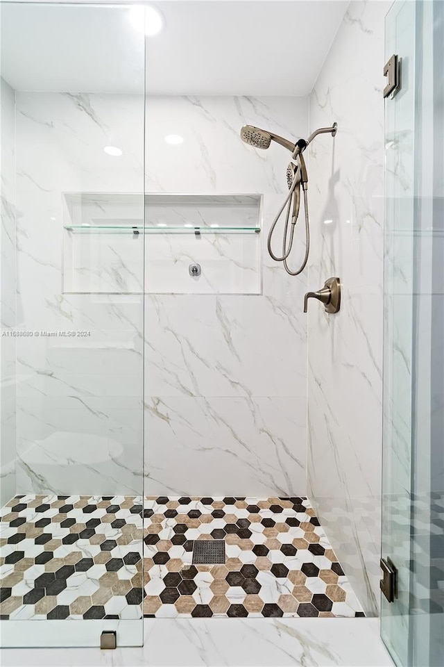 bathroom featuring a shower with door