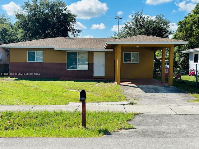 ranch-style home with a front lawn and a carport