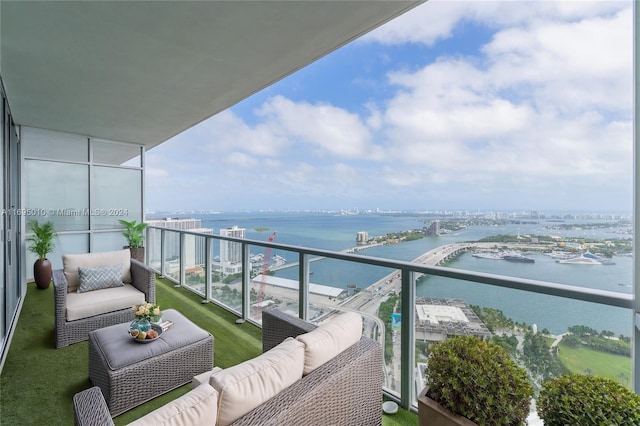 balcony with a water view and an outdoor hangout area