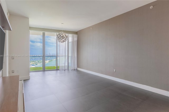 empty room with a notable chandelier and a water view