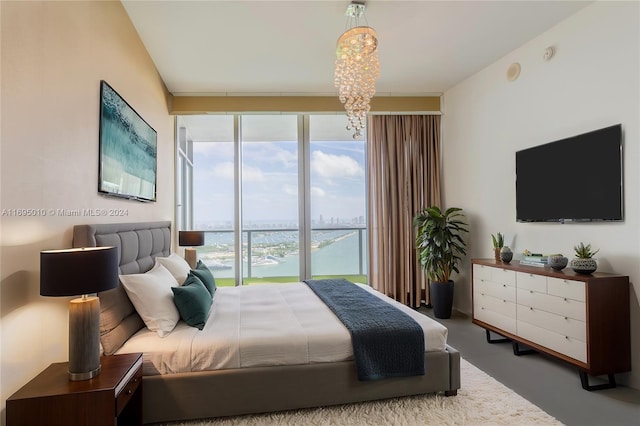 bedroom featuring a notable chandelier and floor to ceiling windows