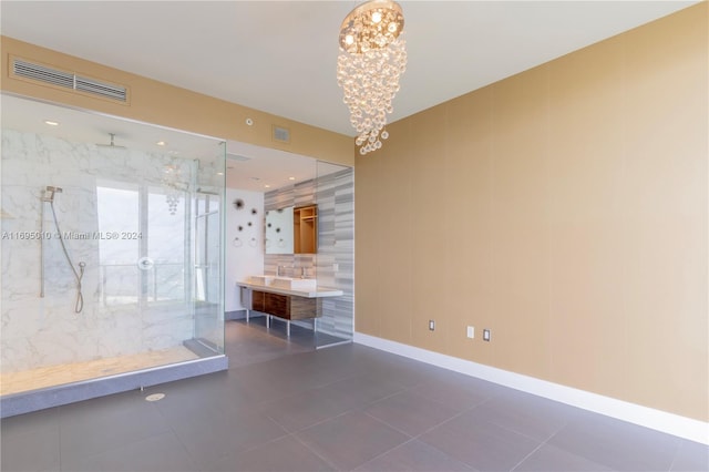 interior space with a chandelier and dark tile patterned flooring