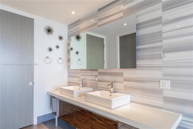 bathroom featuring vanity, tile walls, and tasteful backsplash