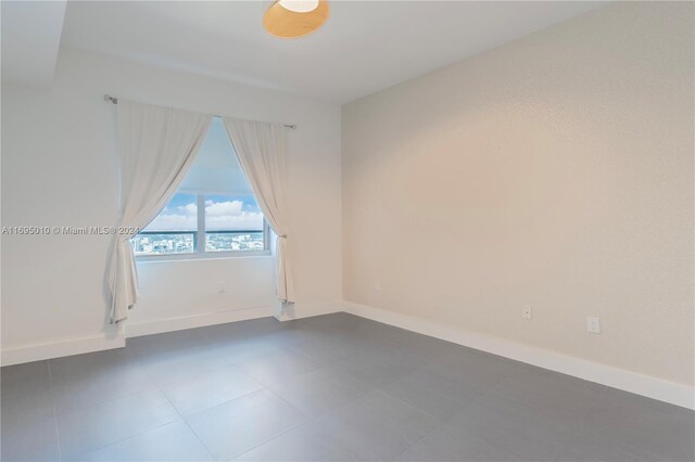 1100 Biscayne Blvd Unit 4502, Miami, FL 33132 - empty room featuring baseboards and dark tile patterned floors