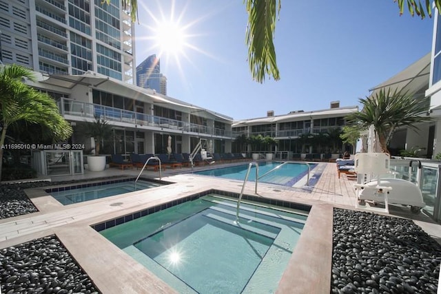 view of swimming pool with a patio area and a community hot tub