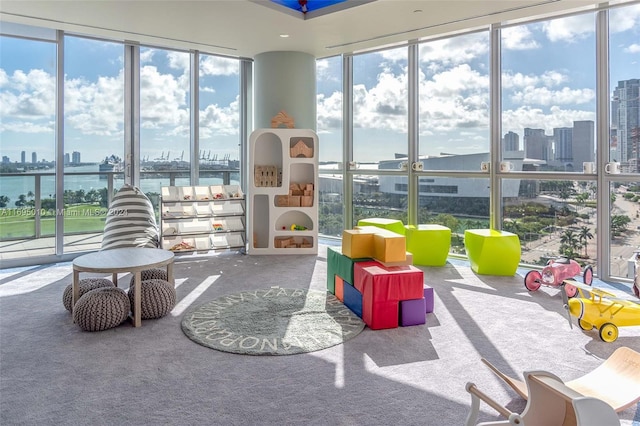 sunroom featuring a water view