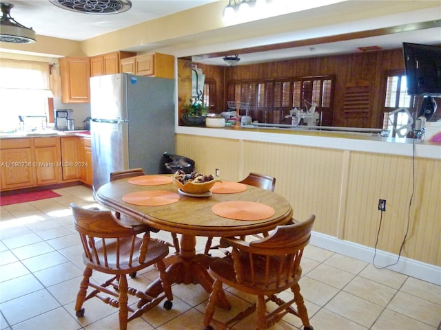 dining space with a wealth of natural light, sink, and light tile patterned flooring