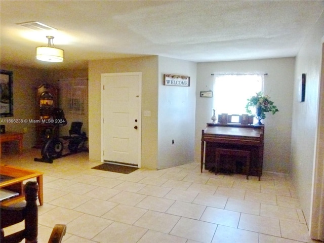 hall with light tile patterned floors