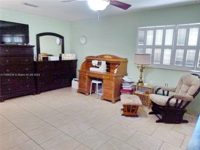 living area featuring ceiling fan and light tile patterned floors