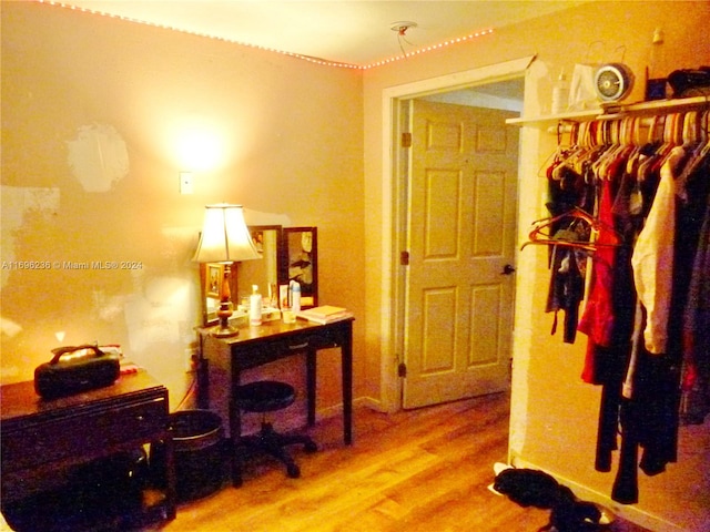 hallway with hardwood / wood-style floors