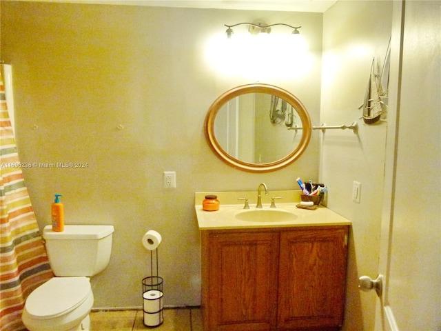 bathroom with tile patterned floors, vanity, and toilet