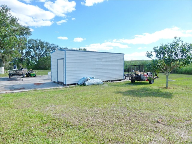 view of outbuilding featuring a yard