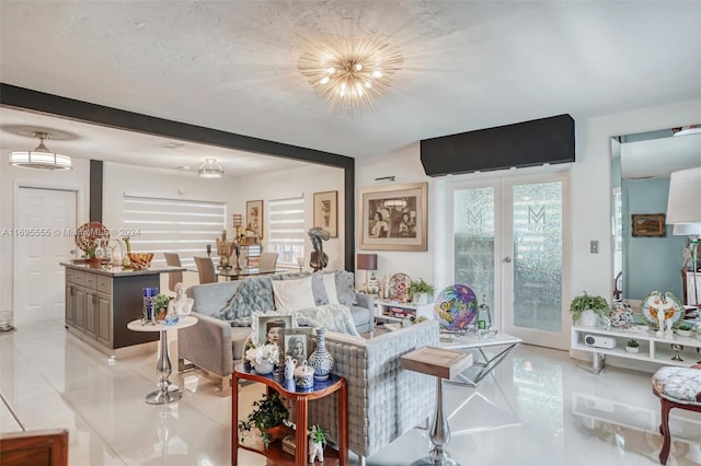 living room featuring a chandelier, french doors, and light tile patterned floors