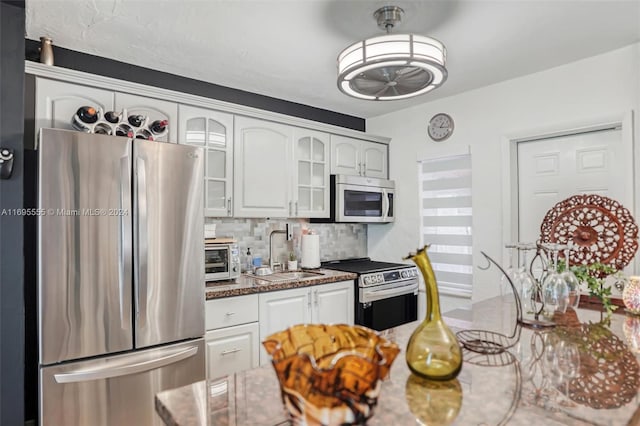 1900 SW 21st Ave, Miami, FL 33145 - kitchen featuring appliances with stainless steel finishes, tasteful backsplash, glass insert cabinets, and white cabinets