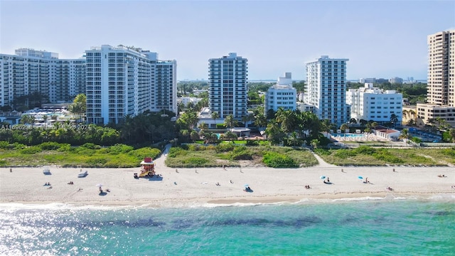 bird's eye view featuring a water view and a beach view