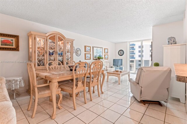 dining area with light tile patterned floors and a textured ceiling