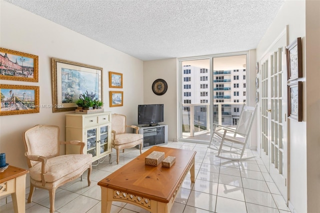 living room with light tile patterned floors, a textured ceiling, and floor to ceiling windows